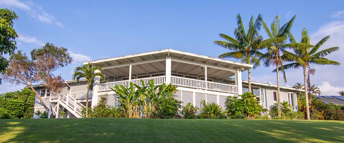 Residential treatment center exterior with palm trees and lawn