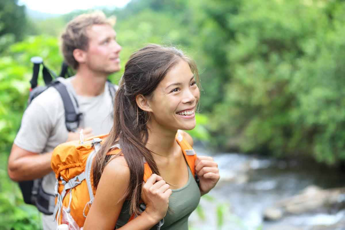 Two patients from a residential treatment center receiving experiential therapy and hiking next to a river
