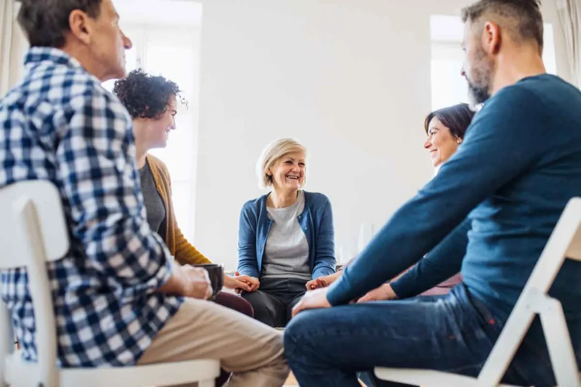 A person receives support from a group therapy session
